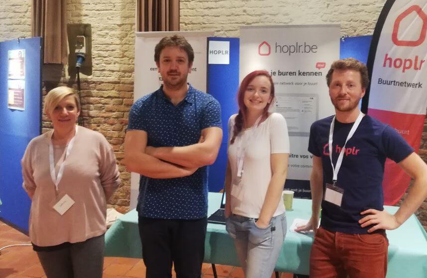  two Hoplr team members and two ambassadors pose together at a trade fair for neighbours in Bruges