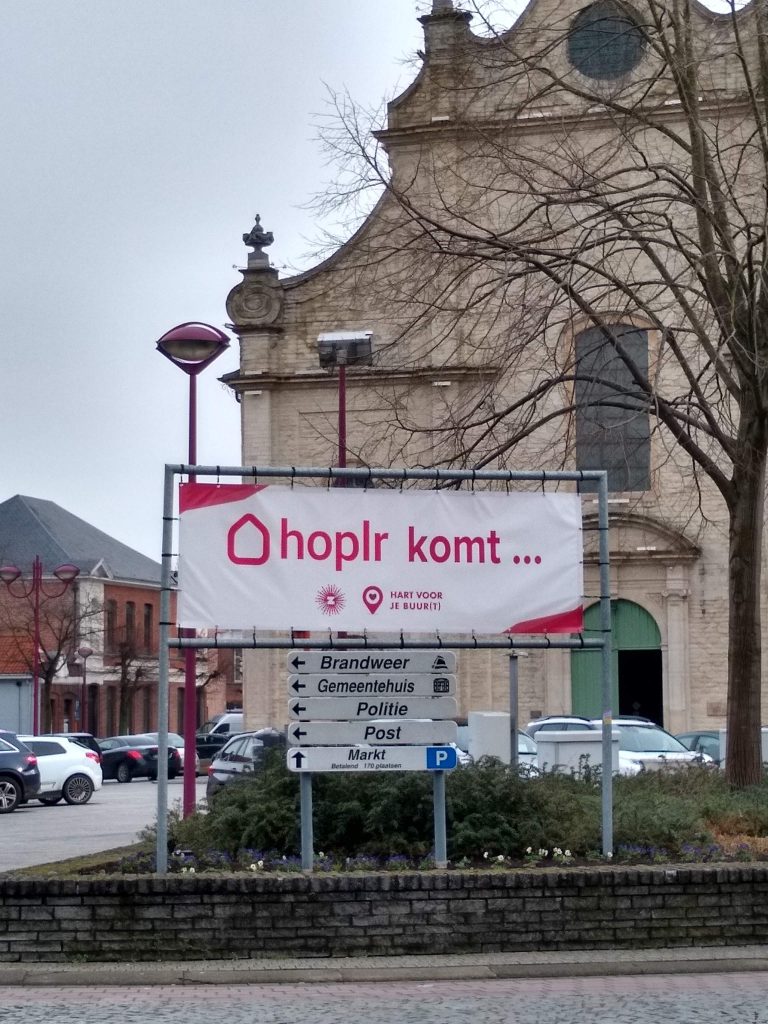 aluminum frame with banner. It says: Hoplr is coming and it has both Hoplr and the municipality of Zele's logo on it